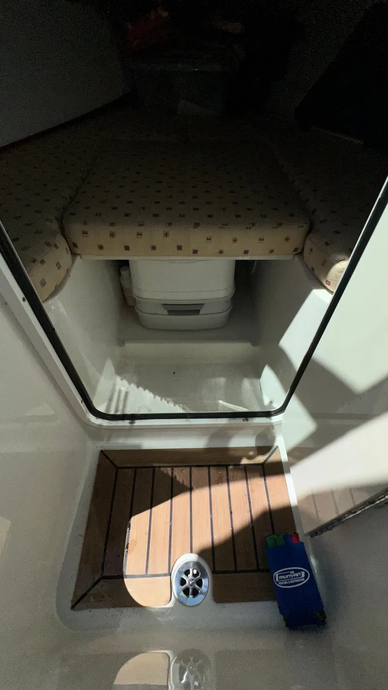 Slide: The Image of 2009 Chris-Craft Corsair 25 cabin interior with wooden flooring and cushioned seating. - 25