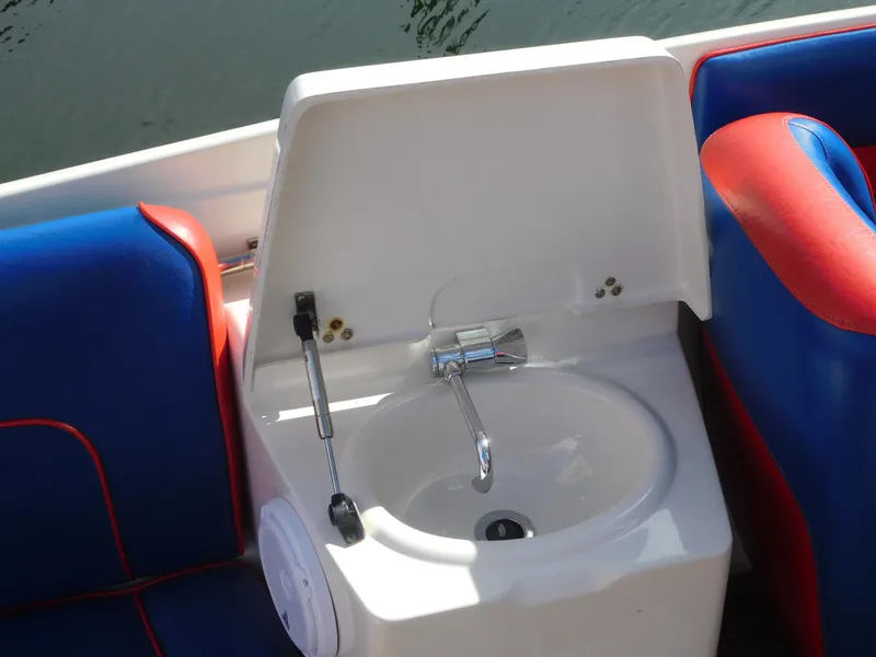 Slide: The Image of 2009 Chris-Craft Corsair 25 boat sink with blue and red seating. - 30