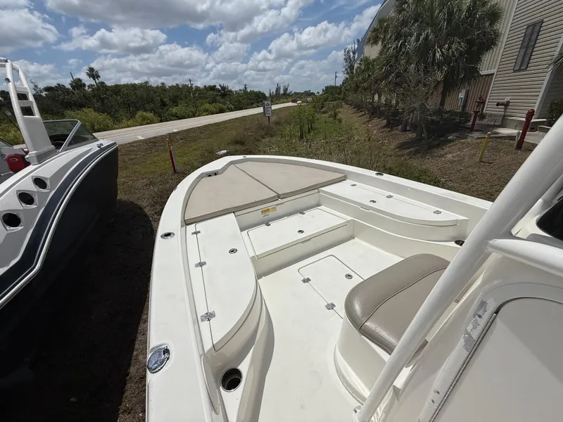 Slide: The Image of 2015 NauticStar 244 XTS boat with seating, docked outdoors under a cloudy sky. - 16