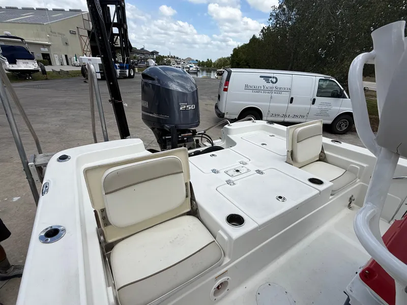 Slide: The Image of 2015 NauticStar 244 XTS boat with Yamaha 250 engine, docked near service vans. - 18
