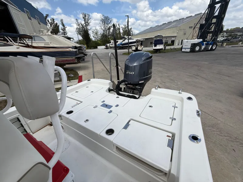 Slide: The Image of 2015 NauticStar 244 XTS boat with 250 HP engine at a marina. - 19