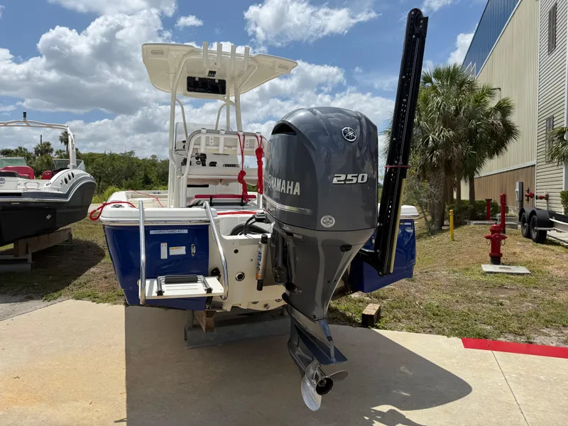 Slide: The Image of 2015 NauticStar 244 XTS boat with Yamaha 250 engine, parked outdoors. - 2