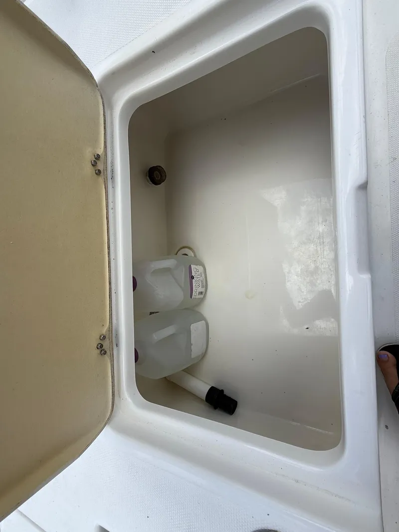 Slide: The Image of Open storage compartment on 2015 NauticStar 244 XTS boat, showing interior space. - 20