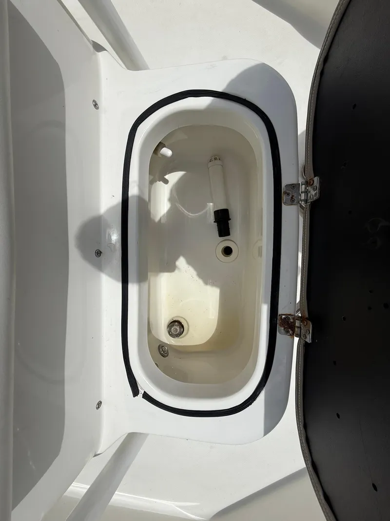 Slide: The Image of 2015 NauticStar 244 XTS boat livewell with open lid, showcasing interior features. - 21