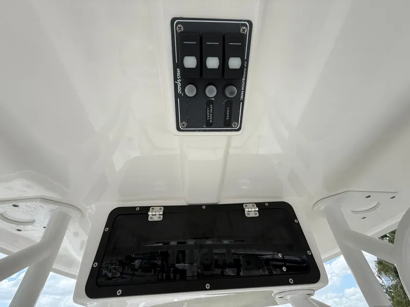 Slide: The Image of 2015 NauticStar 244 XTS boat console with control panel and storage compartment. - 22