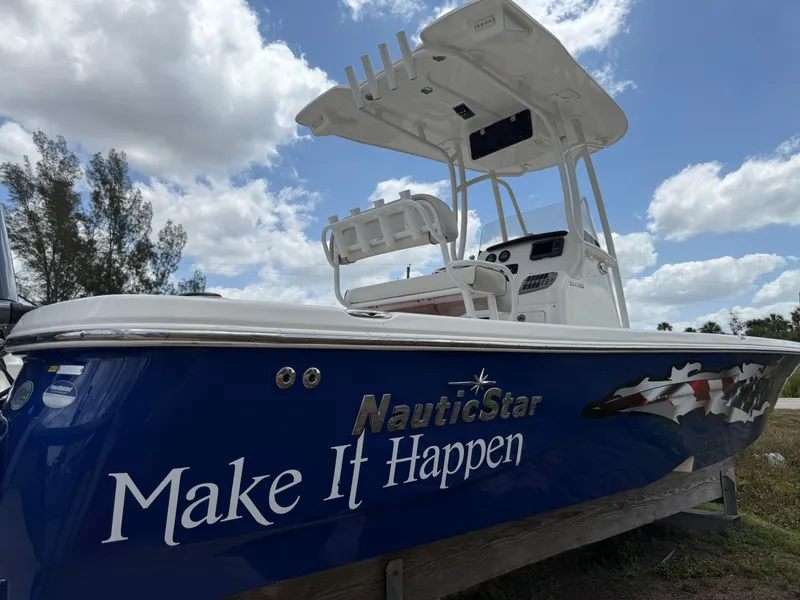 Slide: The Image of 2015 NauticStar 244 XTS boat with "Make It Happen" slogan, under a partly cloudy sky. - 4