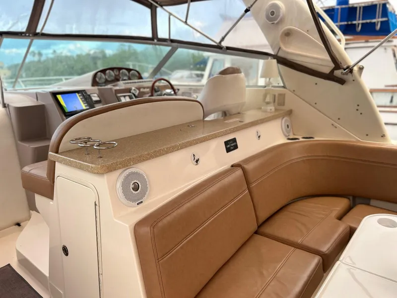 Slide: The Image of 2005 Rinker Fiesta Vee 410 interior with tan leather seating and modern dashboard. - 10