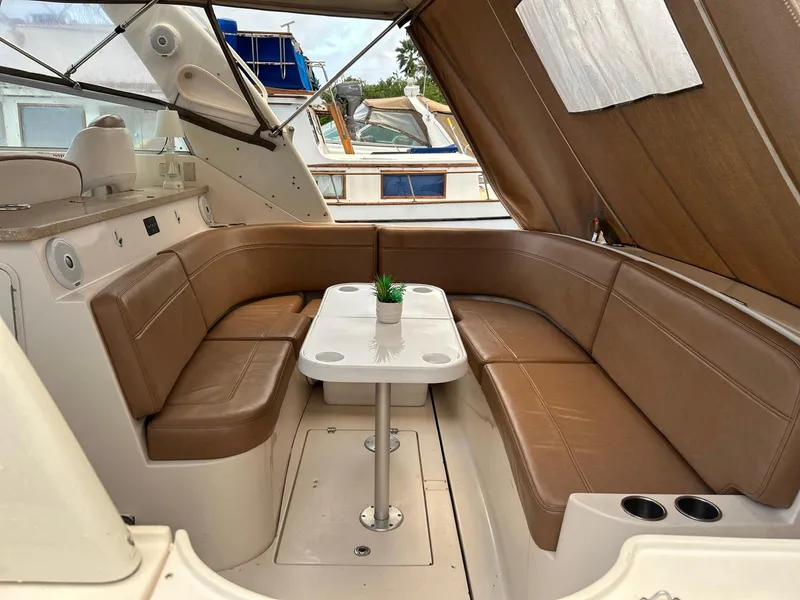 Slide: The Image of 2005 Rinker Fiesta Vee 410 interior with brown seating and table. - 12