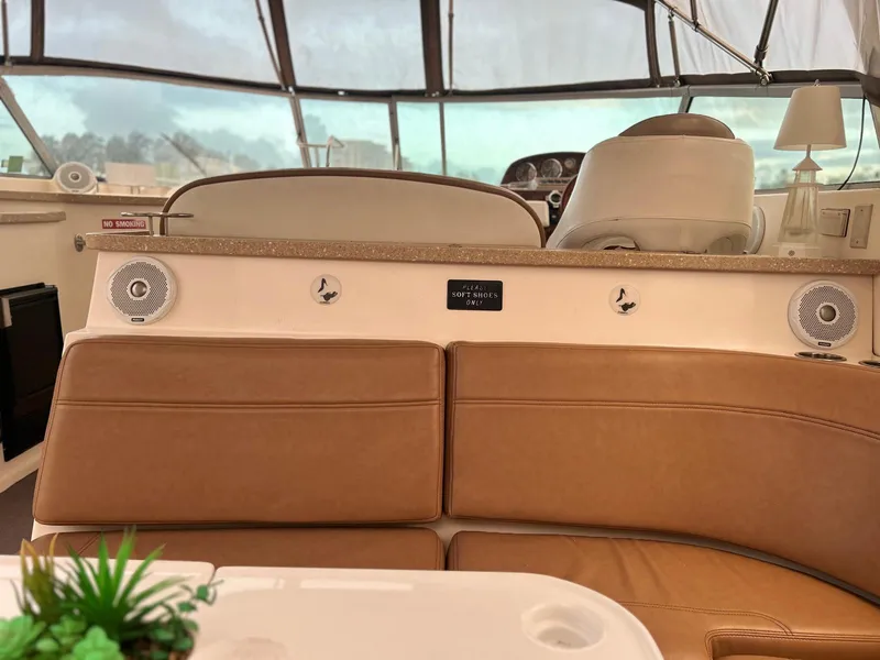 Slide: The Image of 2005 Rinker Fiesta Vee 410 interior with tan seating and helm view. - 13