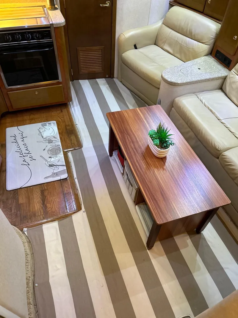 Slide: The Image of Interior of a 2005 Rinker Fiesta Vee 410 with striped flooring and cozy seating area. - 20