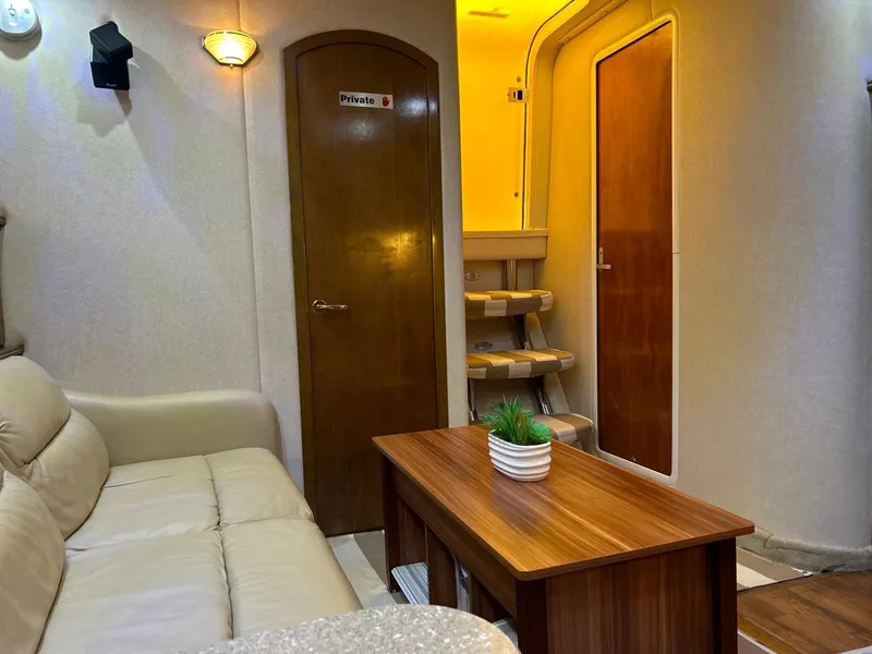 Slide: The Image of Interior of 2005 Rinker Fiesta Vee 410 yacht with cozy seating and wooden table. - 25