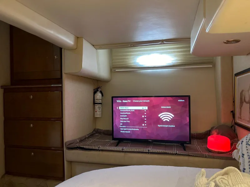 Slide: The Image of Interior of 2005 Rinker Fiesta Vee 410 with TV and cozy decor. - 26