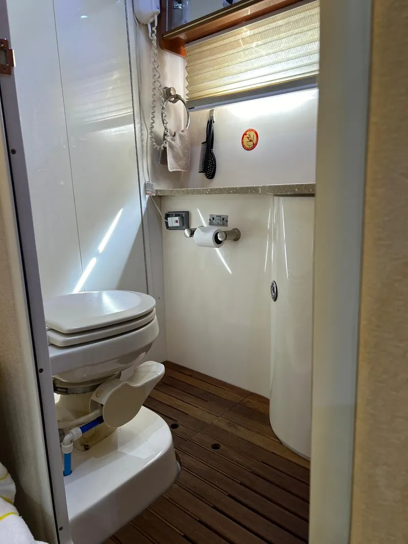Slide: The Image of 2005 Rinker Fiesta Vee 410 boat bathroom with wooden floor and modern fixtures. - 28
