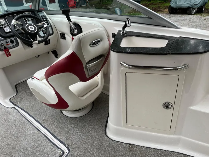 Slide: The Image of 2013 Chaparral 224 Xtreme boat interior with captain's chair and sink area. - 10