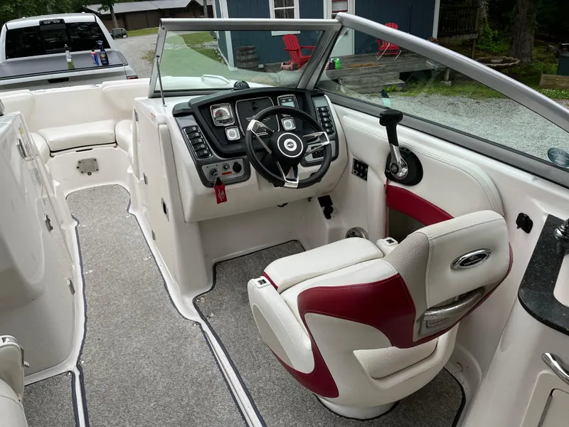 Slide: The Image of 2013 Chaparral 224 Xtreme boat interior with steering wheel and seating. - 11