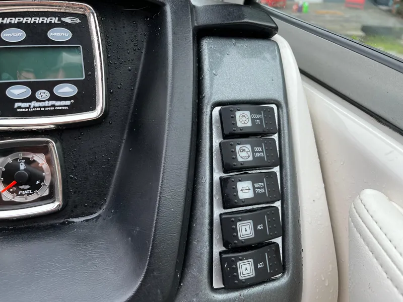 Slide: The Image of Control panel of 2013 Chaparral 224 Xtreme boat with various switches and gauges. - 20