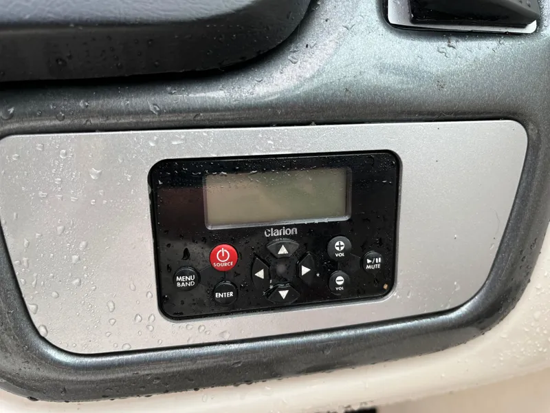 Slide: The Image of Control panel of a 2013 Chaparral 224 Xtreme boat, featuring a Clarion audio system. - 21