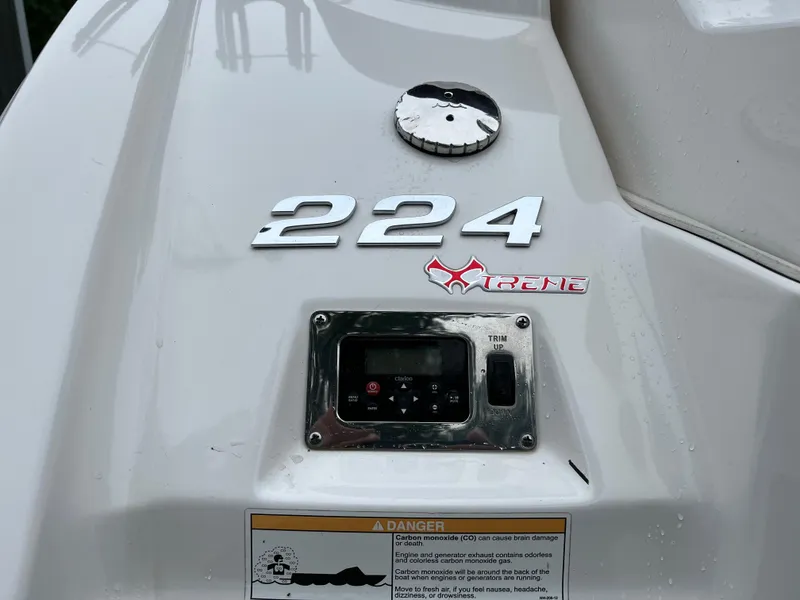 Slide: The Image of 2013 Chaparral 224 Xtreme boat dashboard with control panel and model branding. - 22