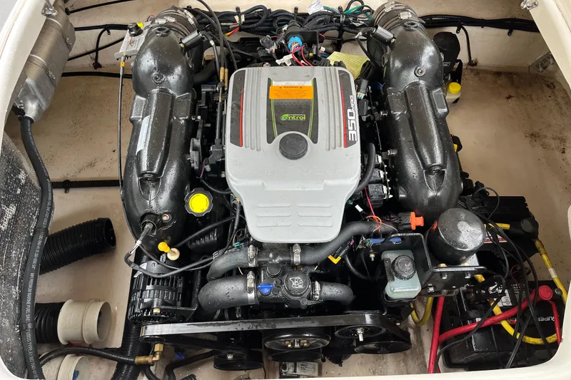 Slide: The Image of 2013 Chaparral 224 Xtreme engine compartment showcasing powerful motor and components. - 23