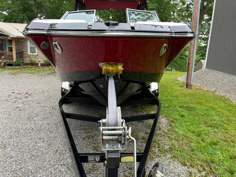 Slide: The Image of 2013 Chaparral 224 Xtreme boat on trailer, parked on gravel driveway. - 26