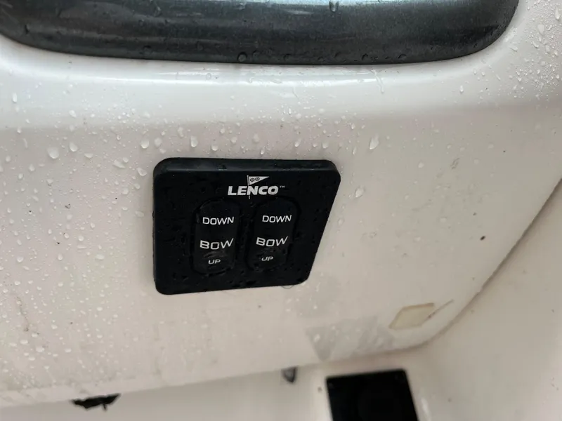 Slide: The Image of Lenco trim tab controls on 2013 Chaparral 224 Xtreme boat, wet surface. - 29