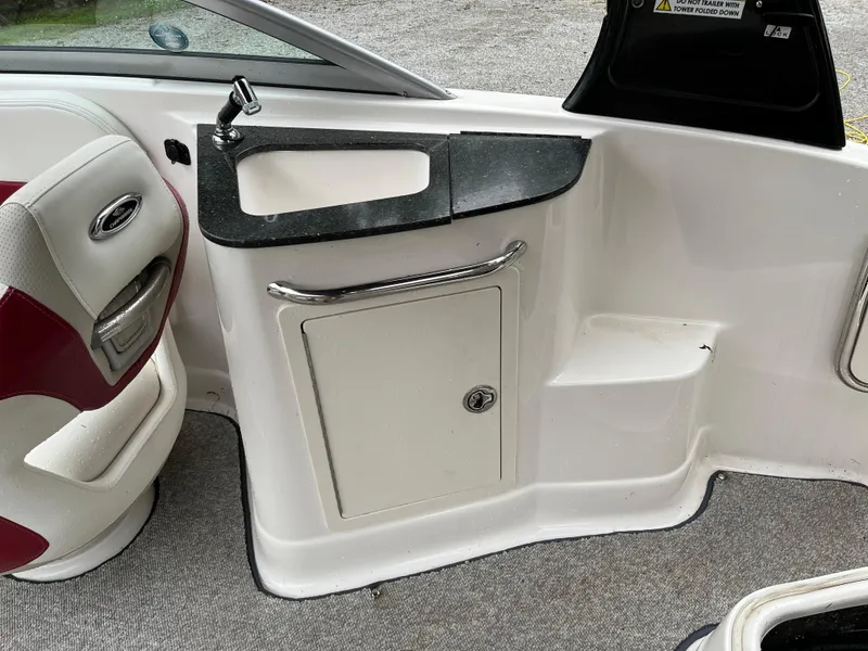 Slide: The Image of 2013 Chaparral 224 Xtreme boat interior with sink and storage cabinet. - 9