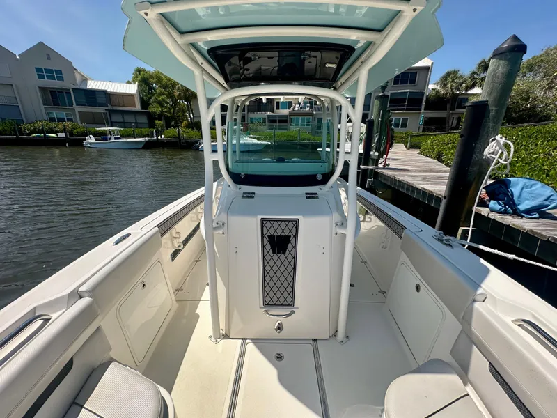 Slide: The Image of 2019 Wellcraft 262 Fisherman boat docked, featuring spacious deck and modern design. - 11