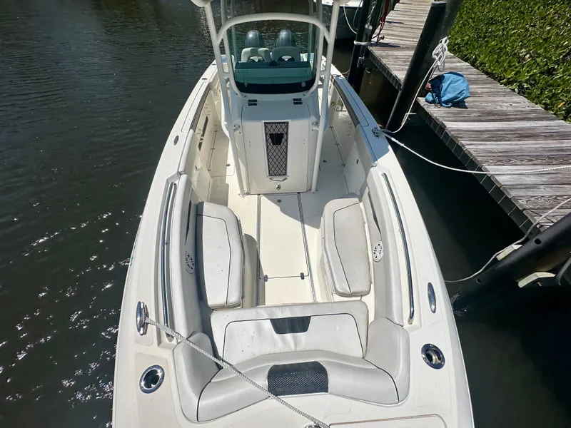 Slide: The Image of 2019 Wellcraft 262 Fisherman boat docked, featuring spacious seating and sleek design. - 12