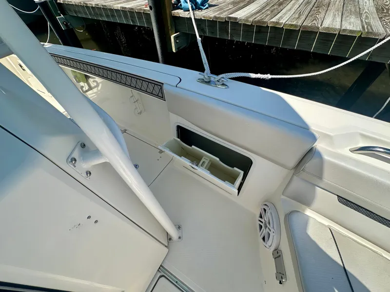 Slide: The Image of 2019 Wellcraft 262 Fisherman boat interior with storage compartment and speaker. - 13