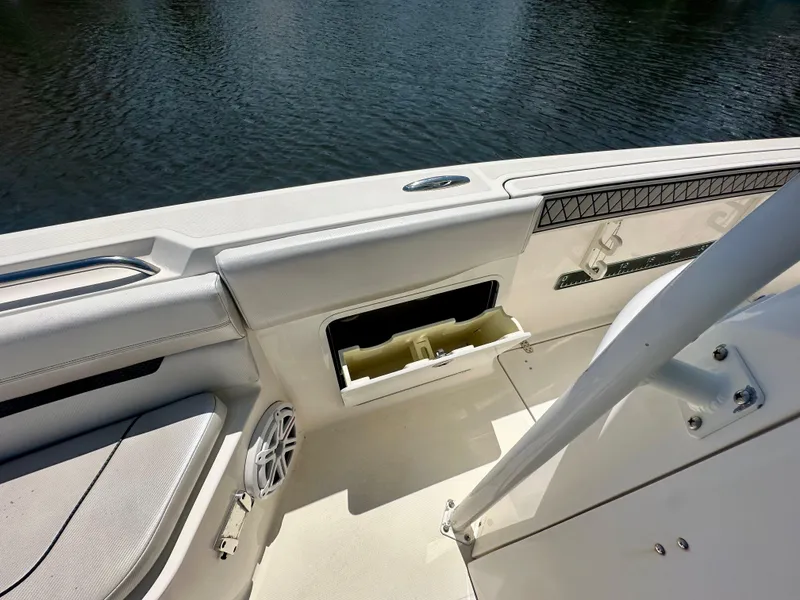 Slide: The Image of 2019 Wellcraft 262 Fisherman boat interior with storage compartment and speaker. - 14