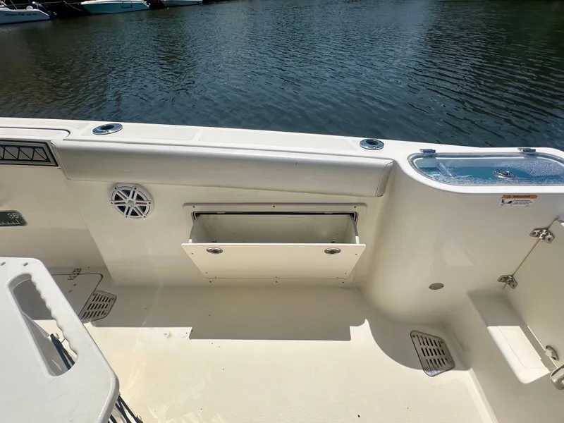 Slide: The Image of 2019 Wellcraft 262 Fisherman boat interior with storage compartment and water view. - 18