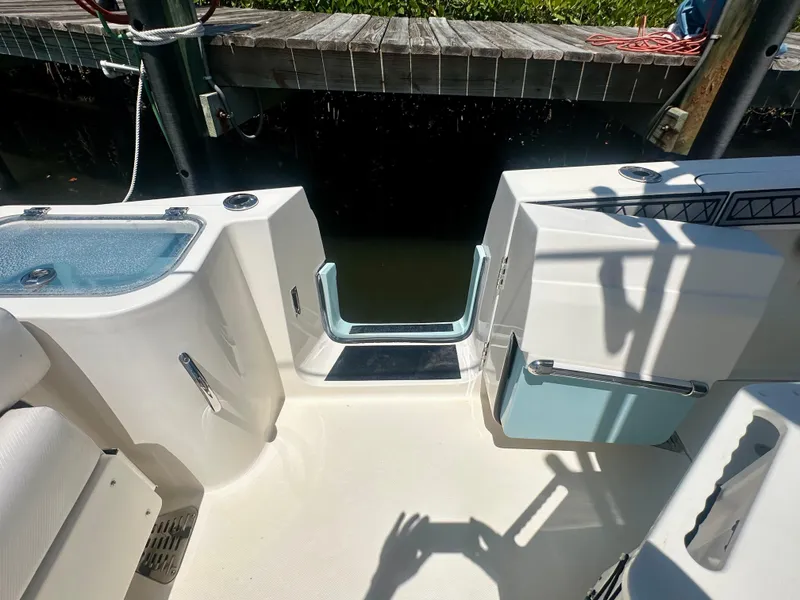 Slide: The Image of 2019 Wellcraft 262 Fisherman boat interior with open transom door and seating area. - 19