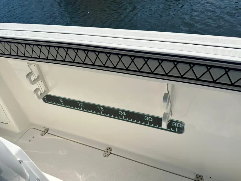 Slide: The Image of 2019 Wellcraft 262 Fisherman boat interior with built-in measuring ruler. - 3