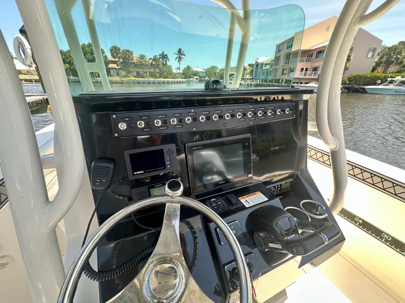 Slide: The Image of 2019 Wellcraft 262 Fisherman boat console with steering wheel and navigation equipment. - 7