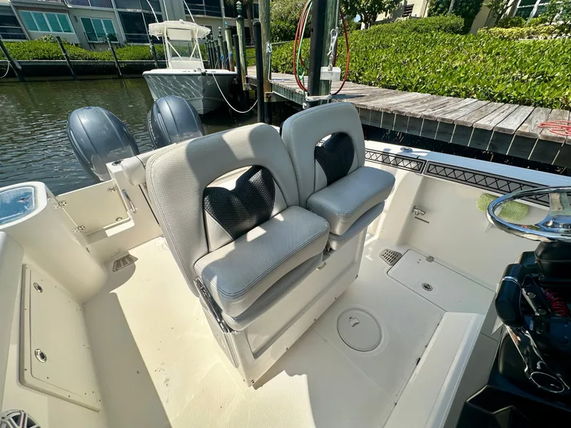 Slide: The Image of 2019 Wellcraft 262 Fisherman boat interior with dual seats and twin outboard motors. - 8