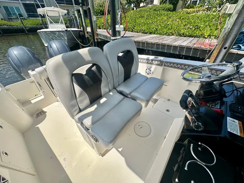 Slide: The Image of 2019 Wellcraft 262 Fisherman boat interior with dual seats and steering console. - 9