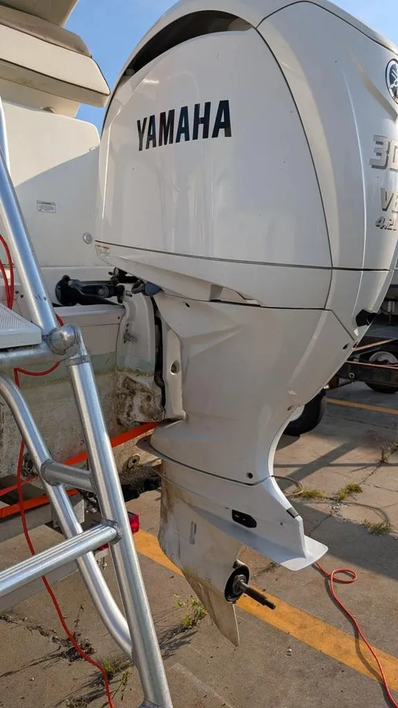 Slide: The Image of Yamaha outboard motor on 2016 World Cat 320 DC boat, docked with ladder nearby. - 11