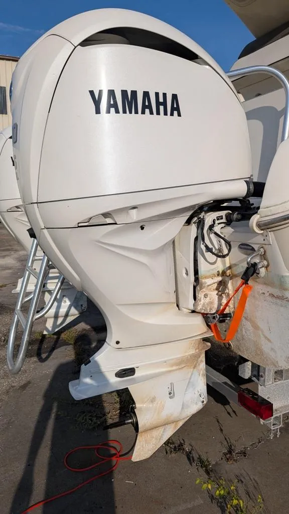 Slide: The Image of Yamaha outboard motor on 2016 World Cat 320 DC boat, docked outdoors. - 12