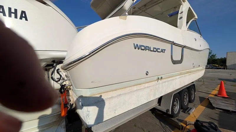 Slide: The Image of 2016 World Cat 320 DC boat on trailer, parked outdoors. - 14