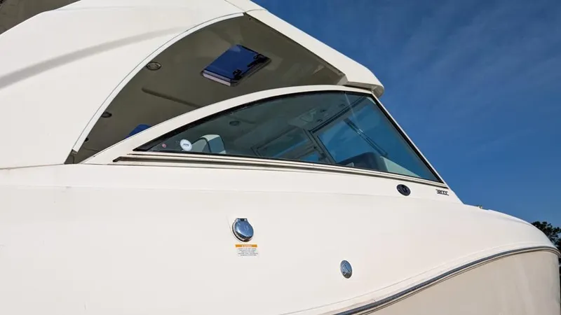 Slide: The Image of 2016 World Cat 320 DC boat, sleek design, white exterior, clear blue sky background. - 20