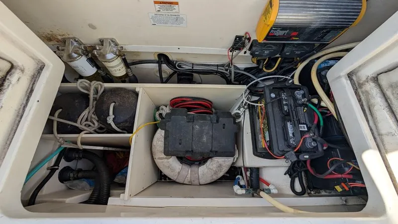 Slide: The Image of 2016 World Cat 320 DC boat engine compartment with wiring and battery setup. - 9