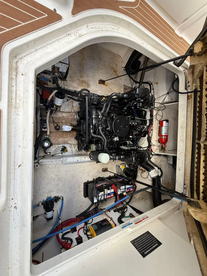 Slide: The Image of Engine compartment of a 2009 Sea Ray 250 Sundancer boat, showing mechanical components. - 11
