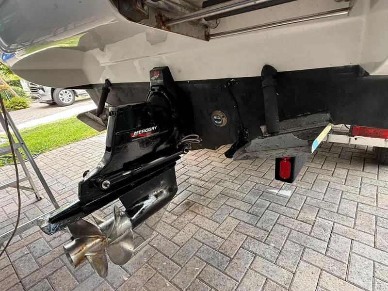 Slide: The Image of 2009 Sea Ray 250 Sundancer boat with MerCruiser outdrive on a brick driveway. - 2