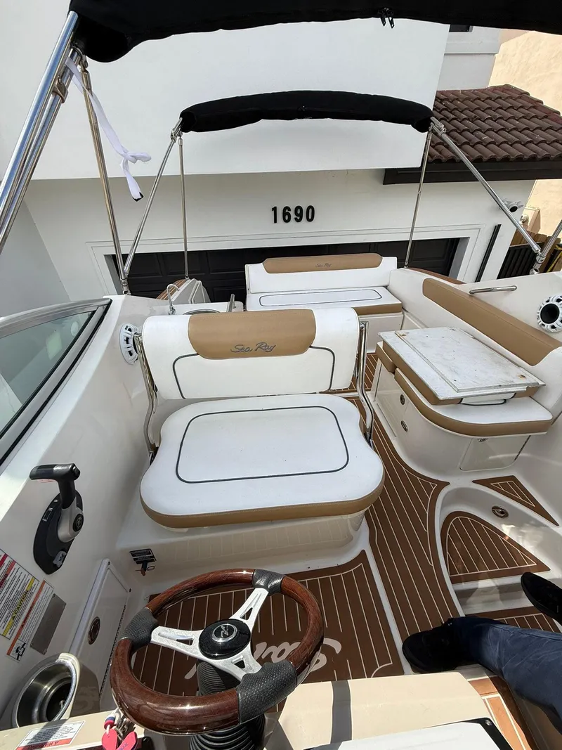 Slide: The Image of 2009 Sea Ray 250 Sundancer boat interior with seating and steering wheel. - 4