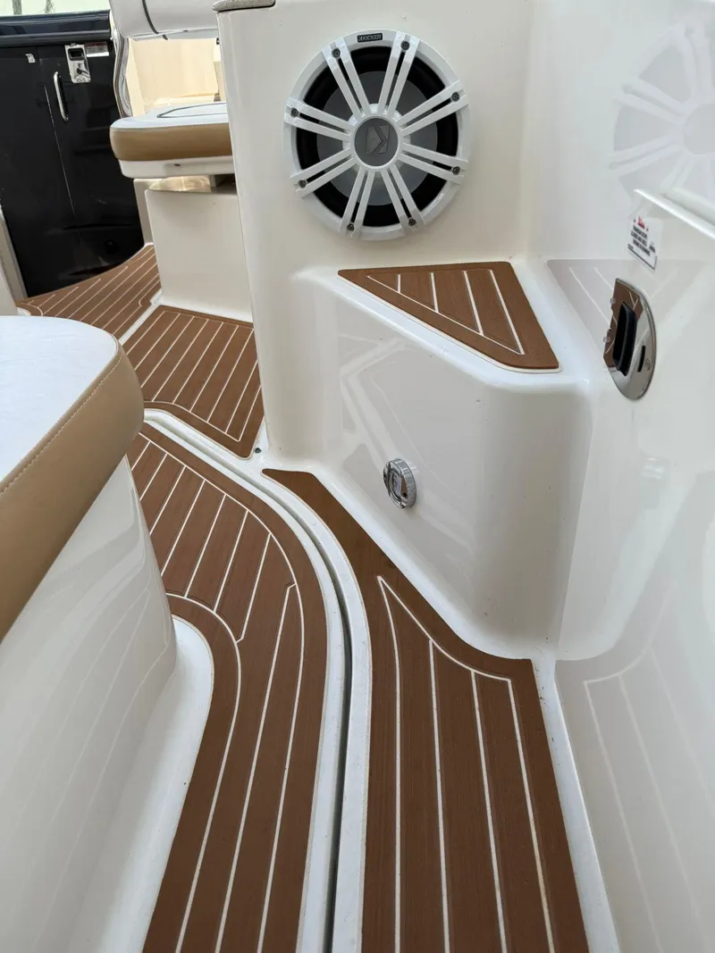 Slide: The Image of 2009 Sea Ray 250 Sundancer boat interior with teak flooring and speaker system. - 5