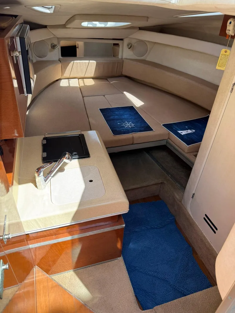 Slide: The Image of 2009 Sea Ray 250 Sundancer cabin interior with seating and kitchenette. - 6