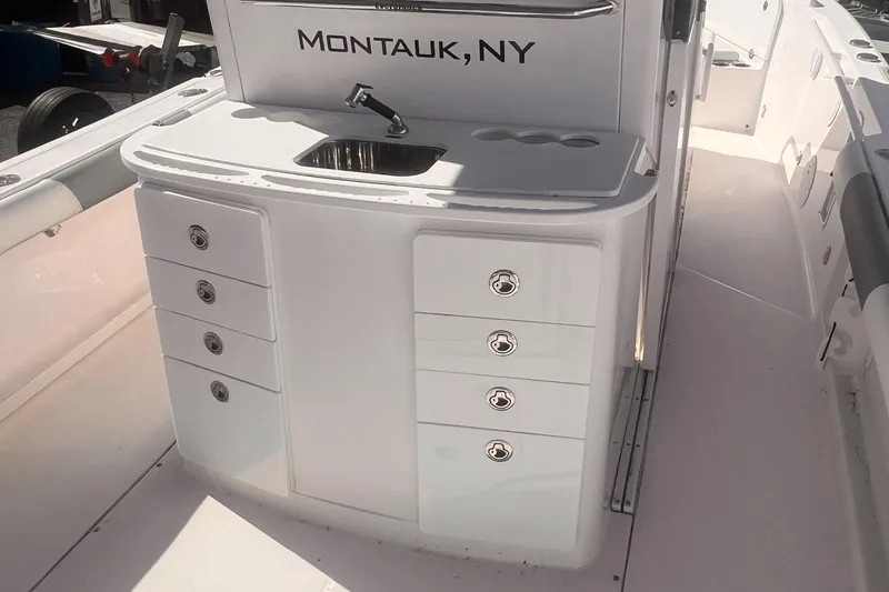 Slide: The Image of 2015 Everglades 295 Pilot boat interior with sink and storage, labeled Montauk, NY. - 4