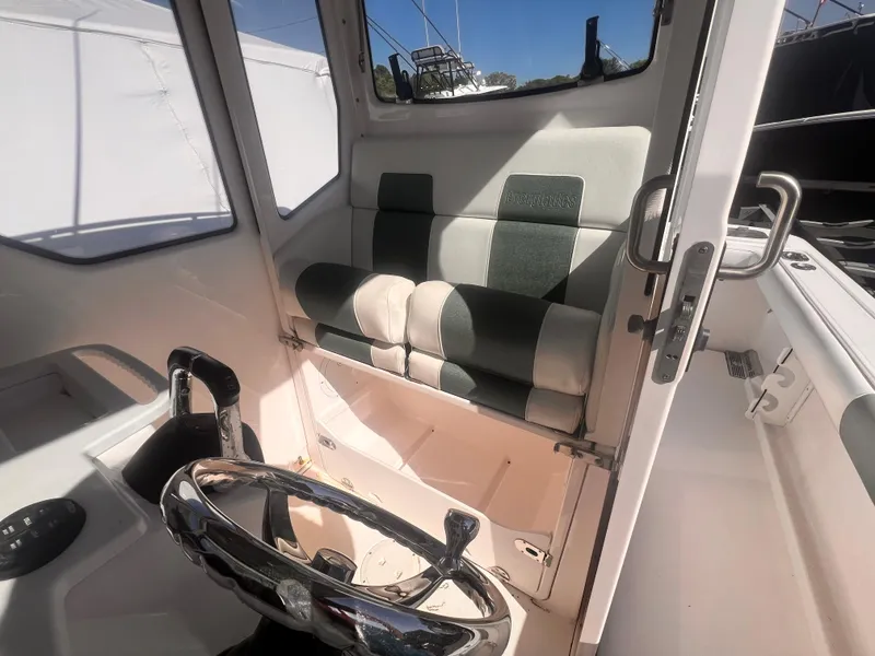 Slide: The Image of Interior of 2015 Everglades 295 Pilot boat with steering wheel and cushioned seat. - 5