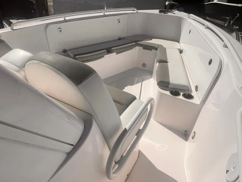Slide: The Image of 2015 Everglades 295 Pilot boat interior with cushioned seating and cup holders. - 7