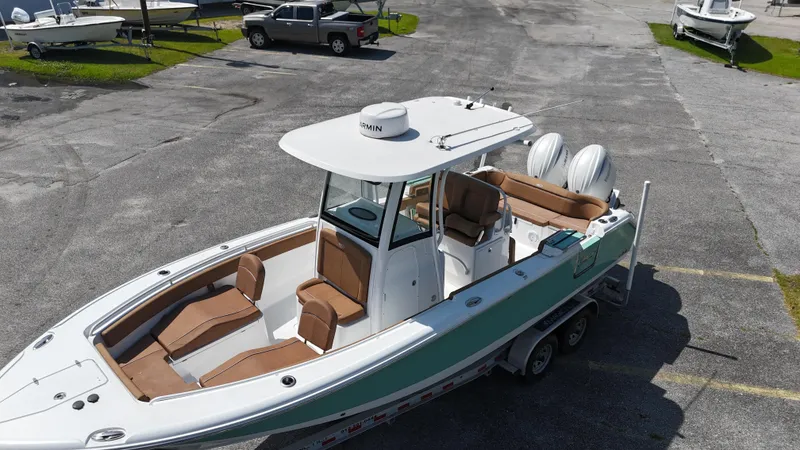 Slide: The Image of 2024 Sea Hunt Ultra 265 SE boat with dual engines, parked on a trailer. - 11